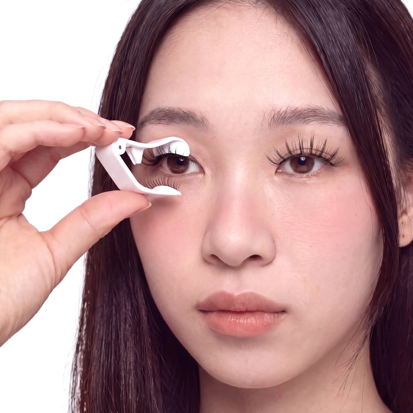 Asian model applying Skyra Beauty magnetic eyelashes with applicator in seconds